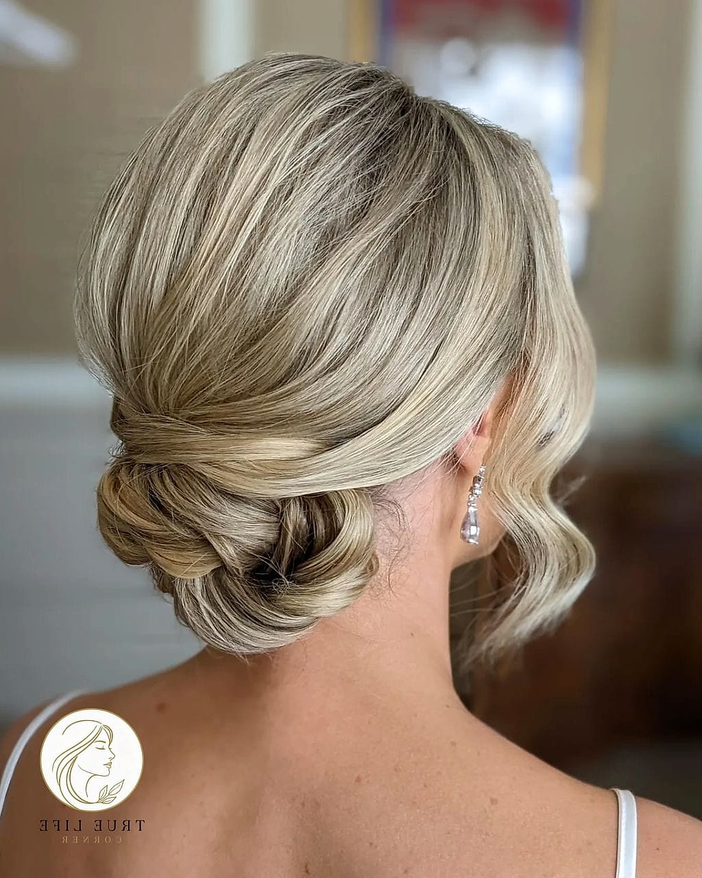 23 Prom Hairstyles For Medium Hair for When You Need a Fresh Change 23 Low Bun With Soft Face-Framing Waves