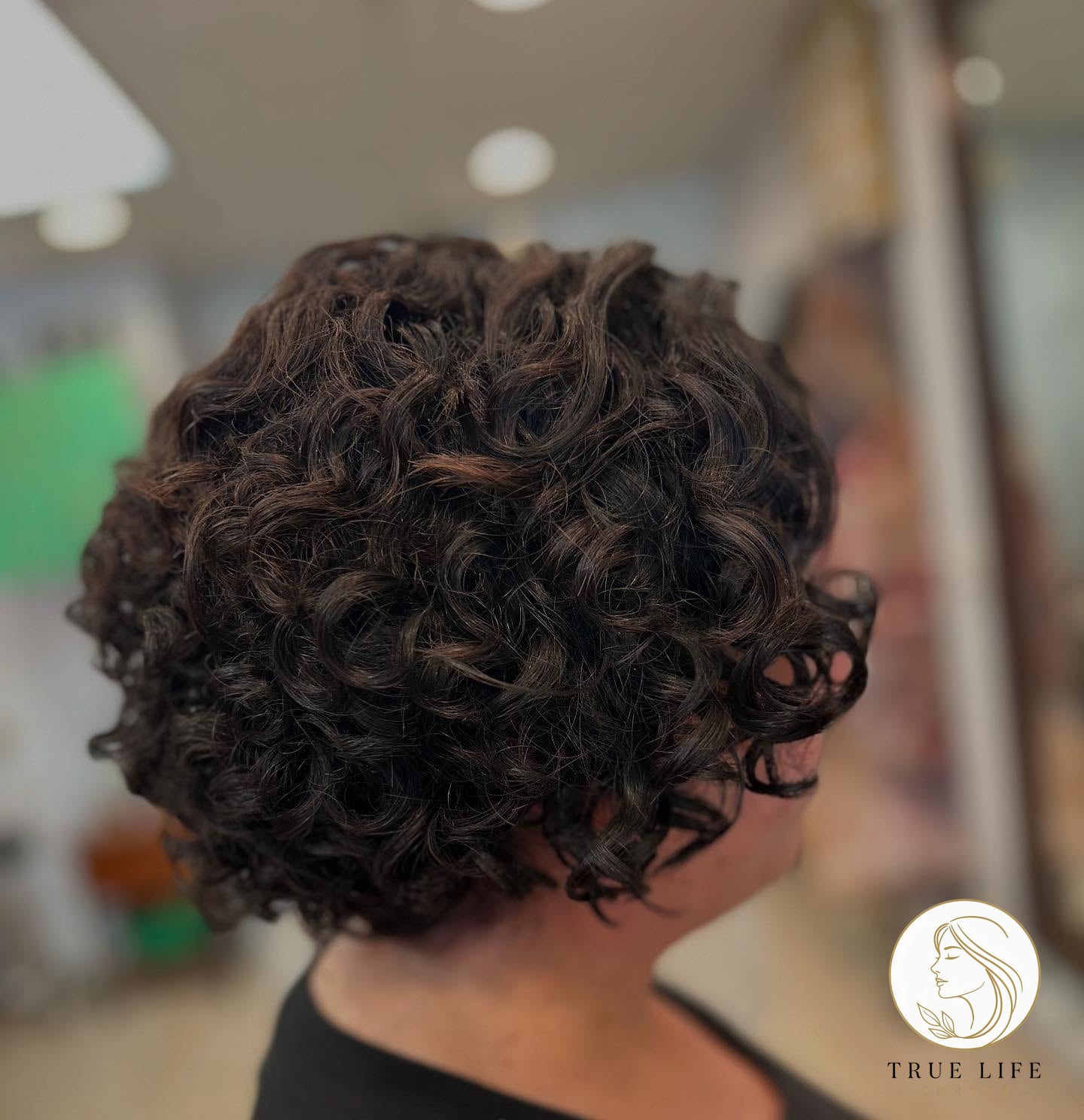 Textured Bob with Tight Curls and Subtle Highlights