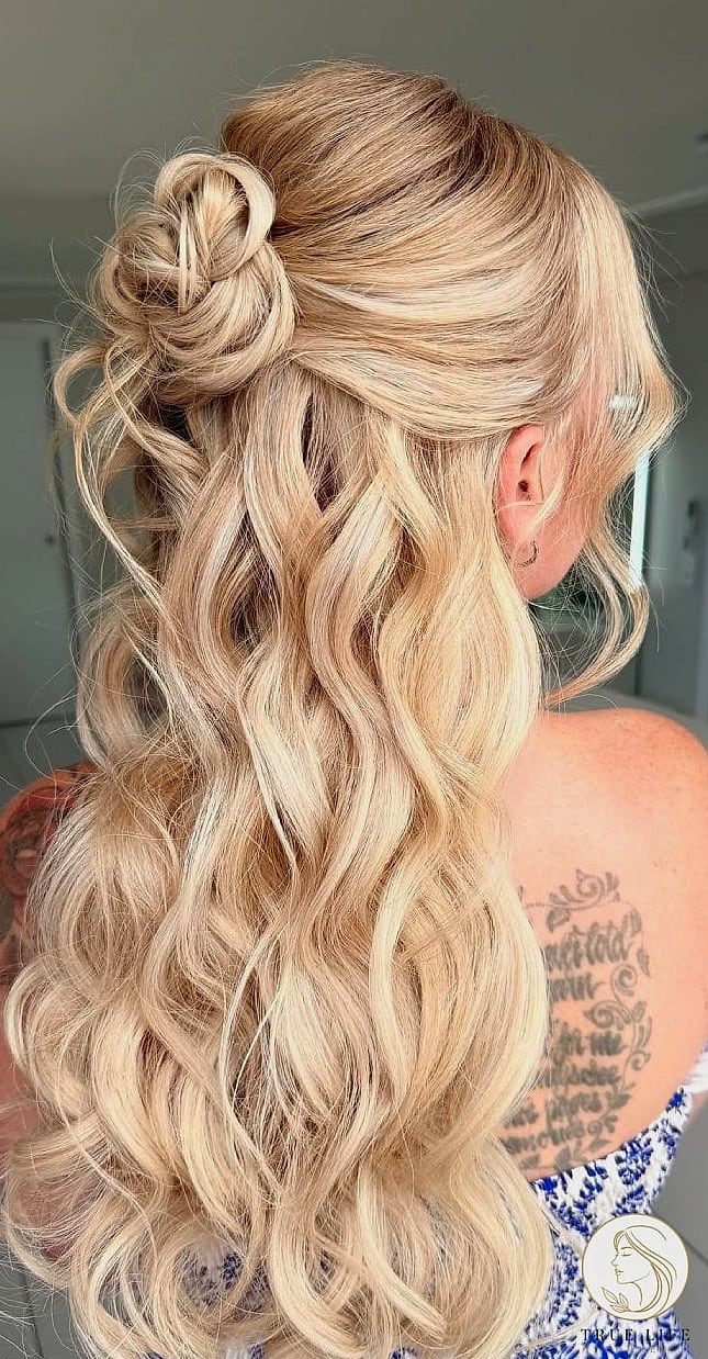 30 Bun Hairstyles For Long Hair That Belong on Your Inspiration Board 8 Half-Up Bun with Loose Waves