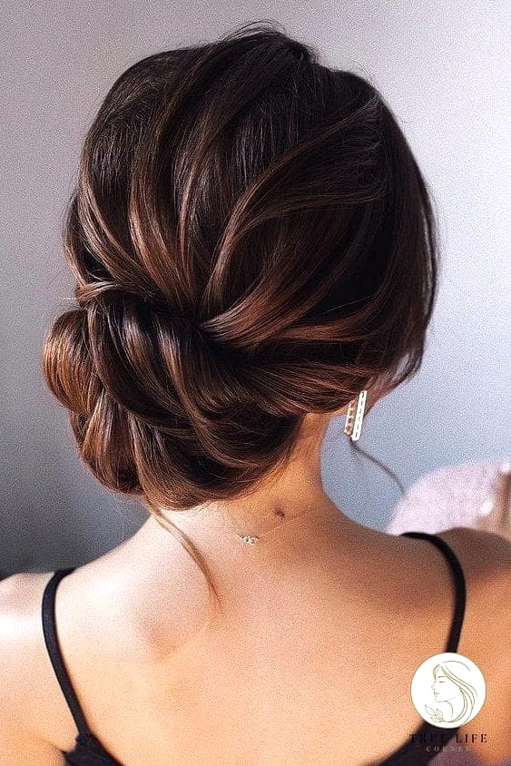 11 Elegant Hairstyles For Long Hair Perfect for Your Next Salon Appointment 11 Low Bun with Face-Framing Tendrils