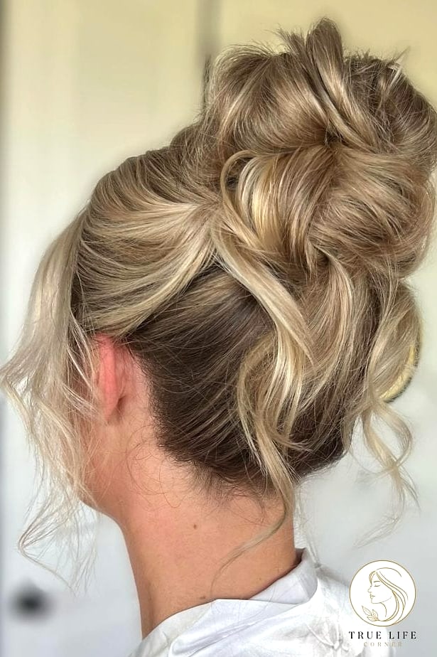 30 Bun Hairstyles For Long Hair That Belong on Your Inspiration Board 24 Messy Top Bun with Face-Framing Pieces