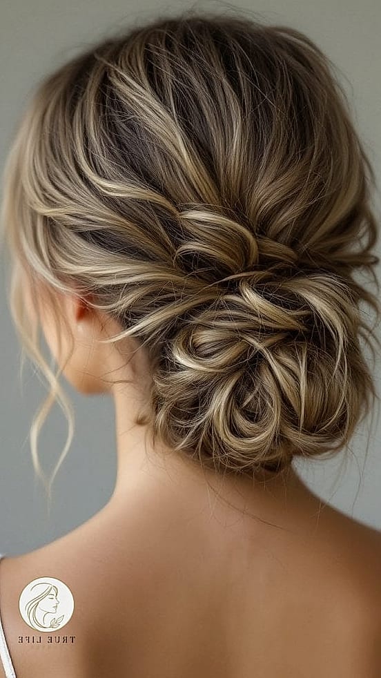 30 Bun Hairstyles For Long Hair That Belong on Your Inspiration Board 17 Textured Low Bun with Volume