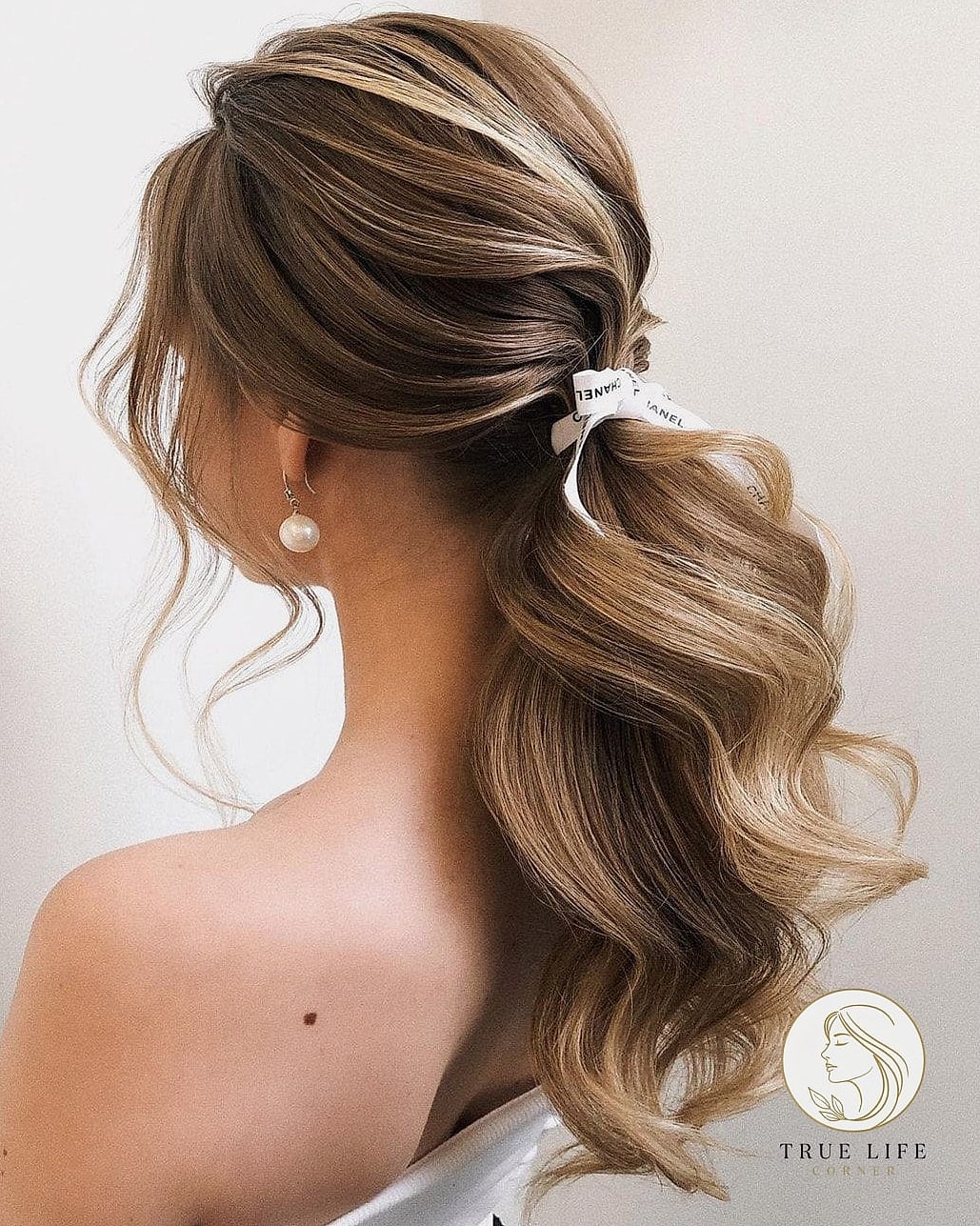 18 Easy Long Hairstyles for the Ultimate Glow Up 18 Textured Ponytail with Wrapped Section