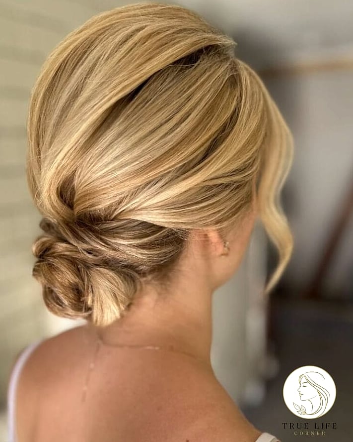 30 Bun Hairstyles For Long Hair That Belong on Your Inspiration Board 7 Twisted Low Bun with Face-Framing Layers