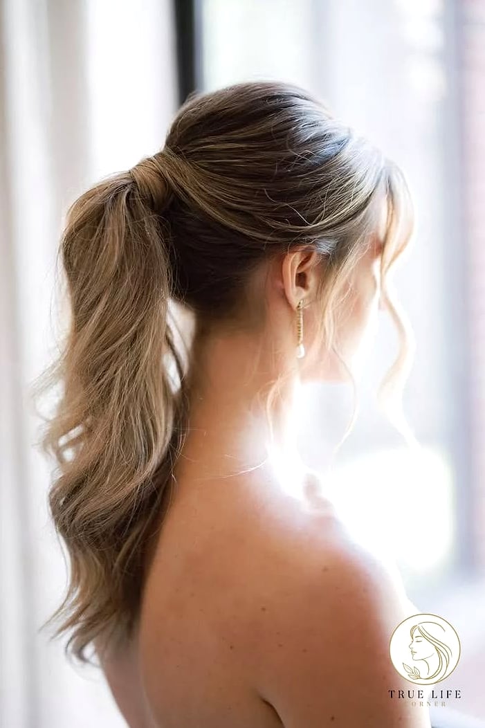 23 Wedding Guest Hairstyles For Long Hair to Transform Your Look Instantly 18 Wavy Ponytail with a Bow